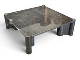 a metal table with a tree in the middle of it