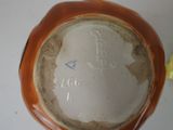 a brown vase with a picture of a woman on it
