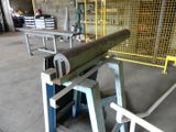 a large metal pipe sitting on a table in a warehouse