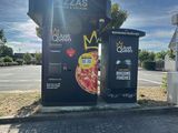 a black box with a pizza on it sitting on the side of the road