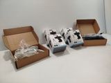 three boxes of electronic devices sitting on a table