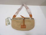 beige straw bag with tan leather handles and a brown leather strap