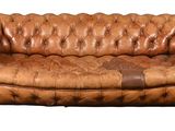 canapé en cuir marron avec une tache marron sur le dossier