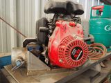 a small engine sitting on a table in a garage