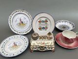 five plates and a cup on a table with a saucer