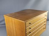 an image of a wooden chest of drawers on a white background