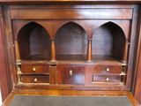 a large wooden cabinet with two doors and a shelf