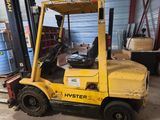 a yellow forklift truck parked in a warehouse