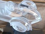 a clear toy car that is on display in a glass case