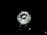 a close up of a white diamond on a black surface