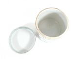 a white bowl and a blue bowl on a white surface