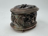 a silver box with a lid on a white surface