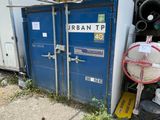 a blue container that is sitting outside of a building