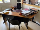 a desk with a chair and a lot of books on it