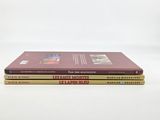 two books are stacked on top of each other on a white surface