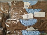 several pairs of brown and blue sweaters are wrapped in plastic