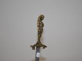 a bronze statue of a man holding a sword on top of a table