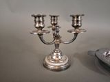 a silver candelab with three candles on it