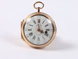 a gold pocket watch with roman numerals on the face