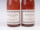 two bottles of wine sitting next to each other on a white surface
