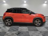 a red suv parked in a garage with a checkered floor