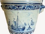 a large blue and white vase with a boat on it