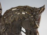 a bronze statue of a man riding a horse