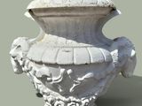 a white vase with a bird on it on a table