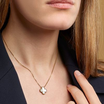 the woman is wearing a black shirt and a gold necklace