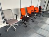 several office chairs lined up against a wall in a row