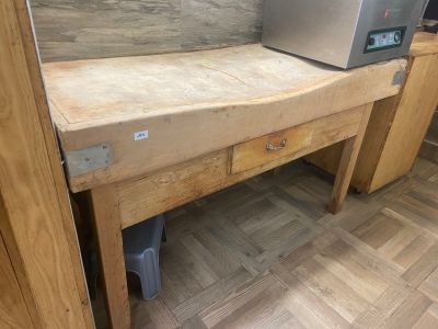 a toaster sitting on a wooden counter in a kitchen