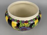 a close up of a bowl with flowers on it