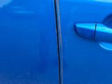 a close up of a blue car door handle