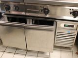 a stainless steel stove and oven in a commercial kitchen