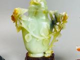three jade figurines sitting next to each other on a table