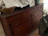 a bed and a dresser in a room with a large window