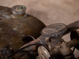 a close up of a motorcycle with a gas can in the background