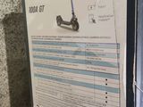 a box with a scooter in it sitting on the floor