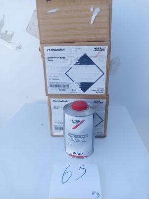 a can of paint next to a cardboard box on a table