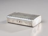 a silver box sitting on a table with a white background