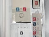 an open book with stamps on it on a table