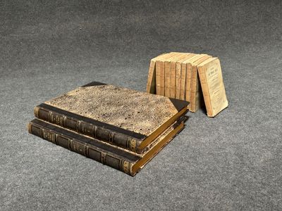 two books are stacked on top of each other on the floor