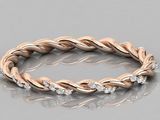 a rose gold braid ring with diamonds on a reflective surface