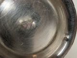 a close up of a metal bowl on a table