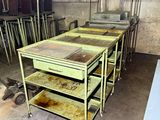 many tables and carts in a room with a lot of shelves