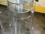 a clear table with a glass top on the floor