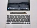 a laptop computer sitting on top of a white table