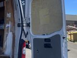 a white van with its door open in a parking lot