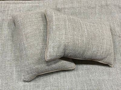 two pillows that are sitting on a couch