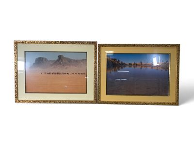 two framed pictures of a desert scene with a lake and mountains